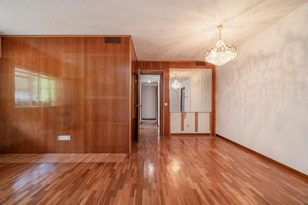 A spacious, empty room showcasing elegant wooden flooring